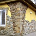 facing the facade of a house with stone